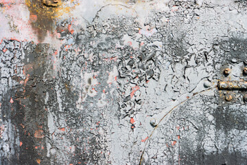 Damaged paint on a metal surface.