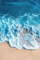 Abstract blue ocean, sand beach and sea foam background. Fresh, cheerful and relaxing summer concept. Aerial view.