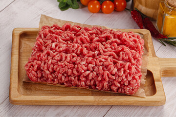 Raw minced beef meat over board