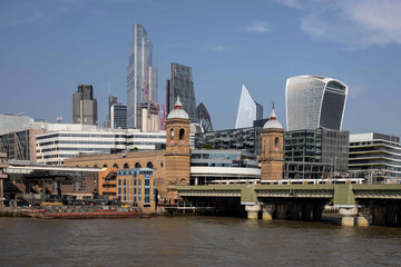 Fototapeta na wymiar Cityscape of the city of London including Cannon Street Railway Station and Bridge taken from over the river Thames