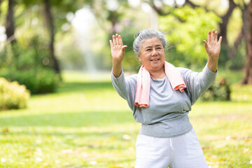asian senior woman workout and practice tai chi in the park