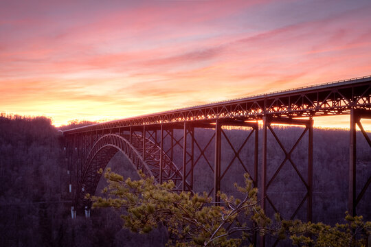 Large metal bridge going through the forest at sunset