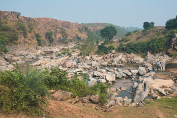flow of Telwa river stream falling through levels of rocky terrain at Dharhara falls in Simultala, Bihar. Water level is knee-deep as flow of water is mostly dried-up in winter season.
