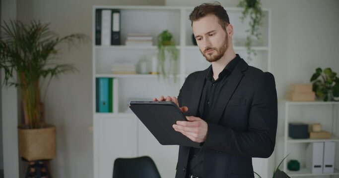 Handsome young male professional using digital tablet