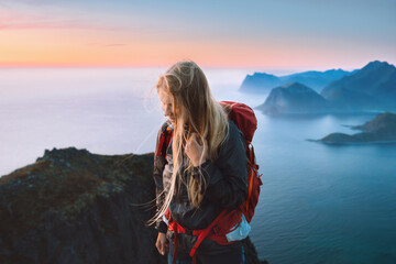 Woman traveling alone in Norway girl traveler hiking in mountains of Lofoten islands outdoor activity healthy lifestyle summer vacations adventure eco tourism happy emotions - obrazy, fototapety, plakaty