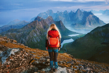 Woman backpacker hiking solo in Norway travel lifestyle female traveler in mountains of Lofoten...