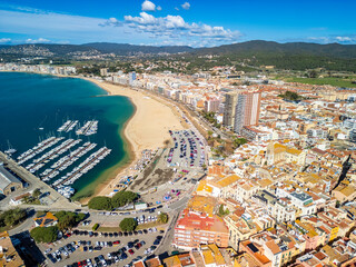 The port of Palamos, visible from above, welcomes majestic cruise ships, adding to the town's allure as a premier European tourist destination.
