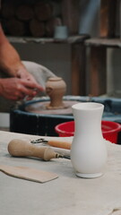 Ceramic Vase and Pottery Tools on Workbench