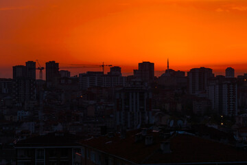 Obraz premium View of amazing sky after sunset over the city of Istanbul, Turkey in the evening - cityscape with residential buildings silhouettes