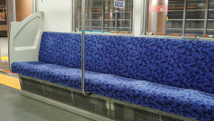 Empty blue seats in the Japanese subway