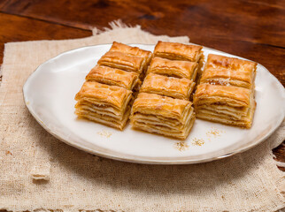 turkish baklava with sugar syrup made of fresh fresh puff pastry as wide banner with copyspace area