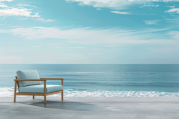A chair is sitting on a beach next to the ocean - obrazy, fototapety, plakaty