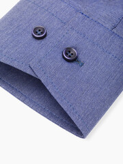 Shirt cuff with buttons on a light background close-up