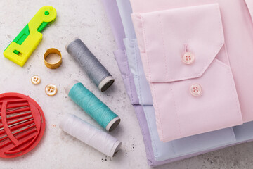 Shirt cuffs, thread and other tools for minor home clothing repairs and button replacement