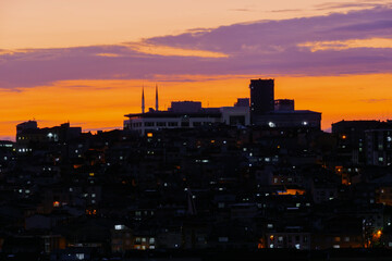 Fototapeta na wymiar View of amazing sky after sunset with clouds over the city of Istanbul, Turkey in the evening - cityscape with residential buildings silhouettes