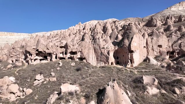 Valley filled with fairy chimneys and ancient settlements in Cappadocia.