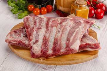 Raw pork ribs over board