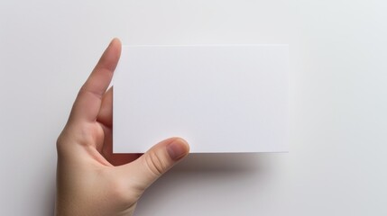 Obraz premium Hand holding business card isolated on white