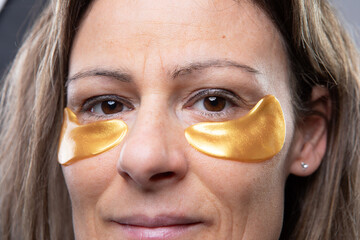 Woman Using Gold Under-Eye Patches for Beauty Routine