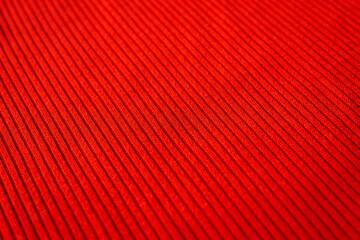 Close-up of red fabric texture with visible threads and patterns. Macro shot for fashion industry,...