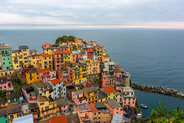 The colorful town of Manarola with cloudy dramatic sky,  Cinque Terre, Liguria, Italy