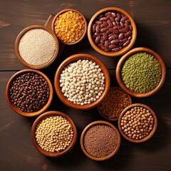 Top view of multicolored legumes in wooden cups on a dark background. Ingredients for vegetarian dishes. Beans, lentils, peas, chickpeas. Healthy eating concepts.