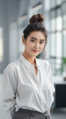 Portrait of happy Chinese businesswoman smiling  in modern office space.