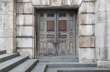 Chains locking an Entrance old wooden iron doors on the side of an St. Paul's Cathedral. Chained up wooden doors with stone steps leading down, Space for text, Selective focus.