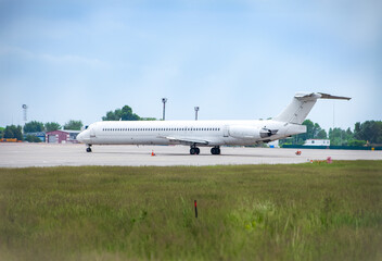 White plane at the airport on the apron. Place for text