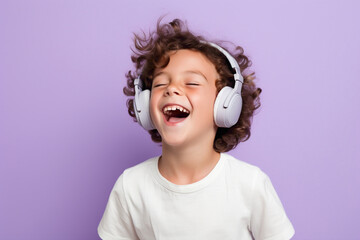 A cheerful kid model, enjoying music on headphones against a lavender solid wall background.