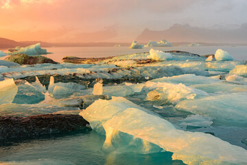 Amazing sunset over the icebergs of the Jokulsarlon Glacier Lagoon,  Iceland - obrazy, fototapety, plakaty