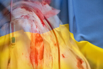 A nurse's robe covered in blood against the background of the Ukrainian flag, war