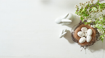 Holiday composition with spring flowers and easter eggs on a light background. Happy easter flat...