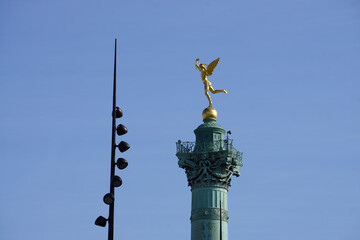 closeup on the golden statue of place de la bastille in downtown paris, france