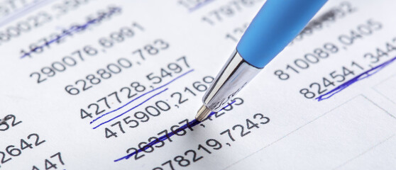 Accounting document with pen, money, coins and checking financial chart. Concept of banking, financial report and financial audit.