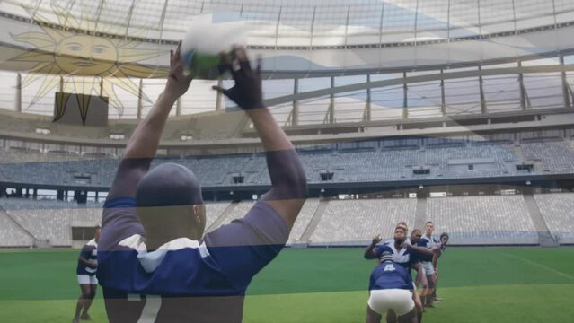 Animation of flag of uruguay over african american rugby player thowing ball to team at stadium