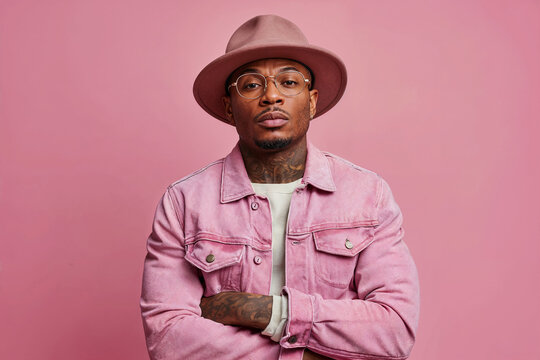 Stylish black man in pink jacket and matching hat on pink background. Generative AI image