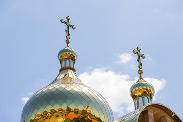 Golden domes with Orthodox crosses against the blue sky - 757535102