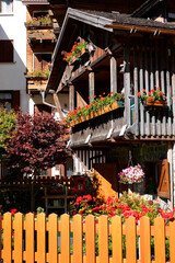 Touristic view of Alleghe resort in the italian Dolomites on bright autumn day, Europe	