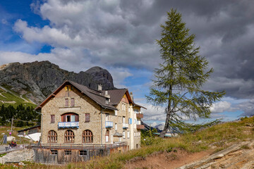 Fototapeta na wymiar A wooden, cozy cottage house in the forest, Dolomites, Italy 