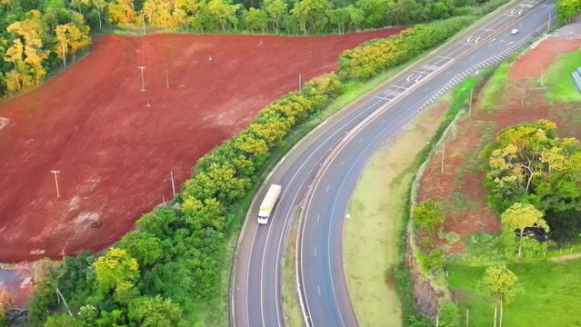 Estrada no fim da tarde com caminh&otilde;es e carros