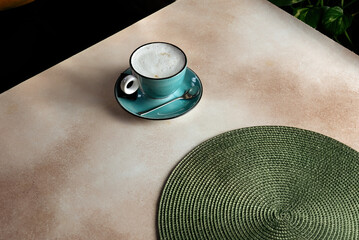 Cappuccino coffee cup with designer mat.