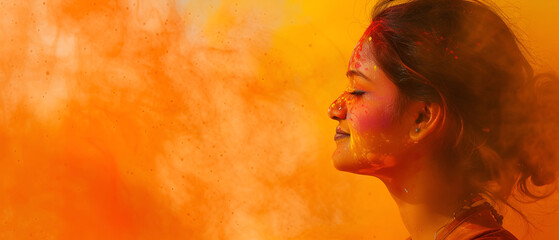 Woman surrounded by yellow paint during Holi festival