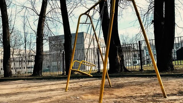 Empty swings on kids playground. Child abduction concept