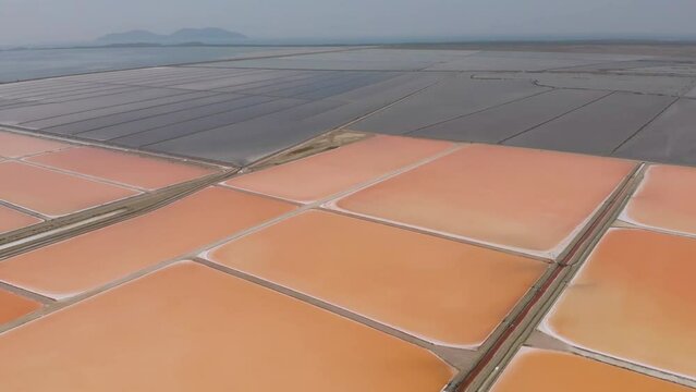 Aerial view above red Salt production pools in Albania - tracking, drone shot