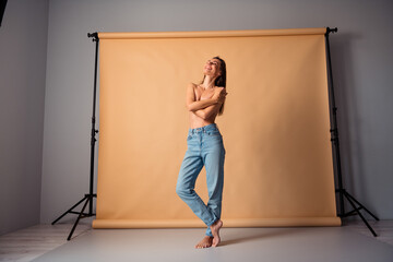 Fototapeta premium Unretouched photo of body positive photographing intimate photo session enjoying cover breast isolated studio background