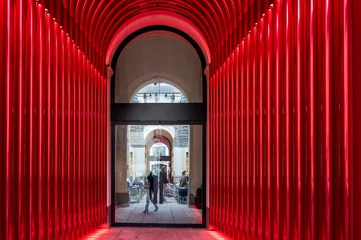 Rolgordijnen Design modern door in red lights in Milan, Italy © barmalini