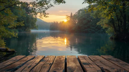 Badezimmer Foto Rückwand A serene view of an empty wooden table top positioned against the blurred backdrop of a tranquil lake at sunset, the calm water and distant forest trees creating a perfect setting for peaceful © Алексей Василюк