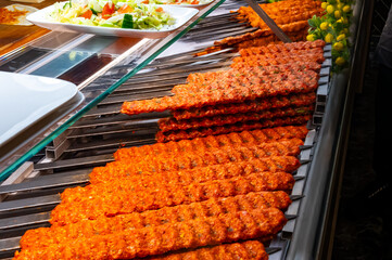 Turkish mixed grill meat, chicken wings, lamb, beef shashlik, kebab cooking on charcoal grill in restaurant