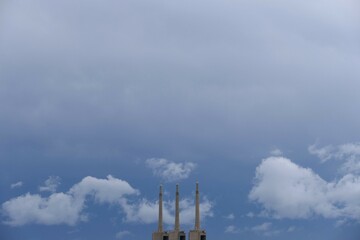 The three chimneys of the Sant Adrià de Besòs thermal power plant, with cloudy sky, Barcelona